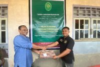 Panitera Pengadilan Negeri Sanana Fahrudin Pora Serahkan Berkas Berita acara Eksekusi Pengosongan Rumah ke Panasehat Hukum Penggugat Kuswandi Buamona (kaos hitam). (Rakyatmu)